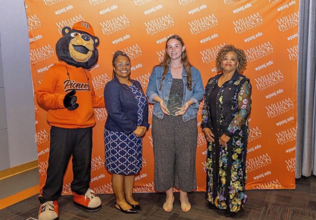 Renee Wells receiving her Roland Watts award 