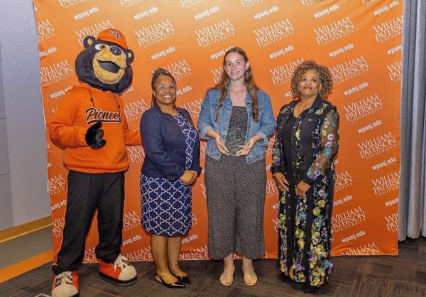 Renee Wells receiving her Roland Watts award 