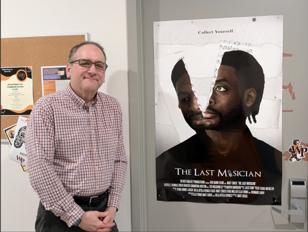Dr. Crick Beside a Poster for “The Last Musician” Outside His Office at William
Paterson University